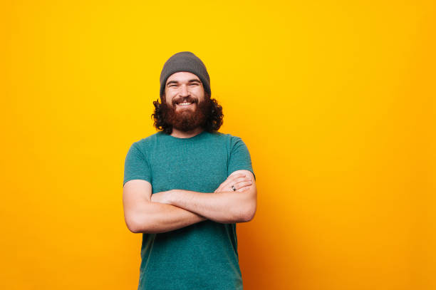istock Cheerful smiling bearded hipster man looking confident at the camera 1195121917