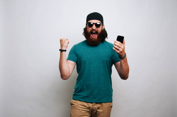 istock Young happy bearded man celebrating 1195123436