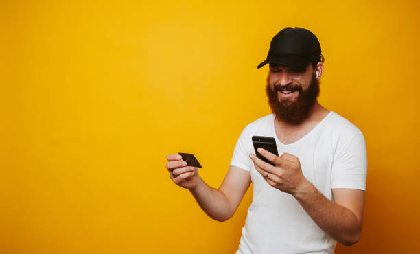 istock Man paying with credit card on smart phone 1195123445