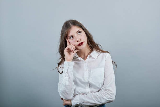 istock Attractive young woman keeping hand on head, thinking about something 1195124308