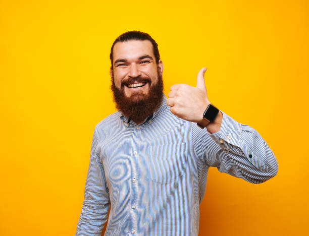 istock Happy bearded man in casual showing thumbs up 1195124533