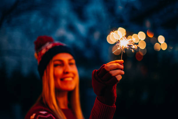 istock Young Woman Holding Sparkler 1195124643
