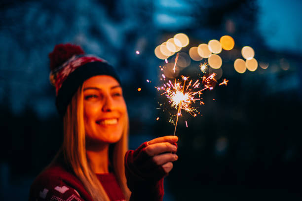 istock Young Woman Holding Sparkler 1195125187