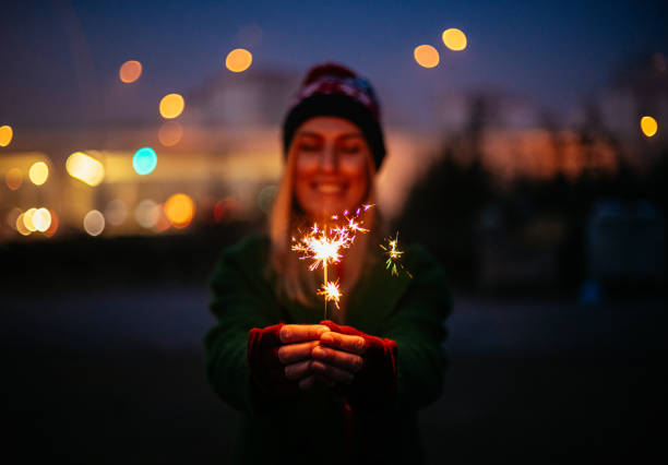 Young Woman Holding Sparkler at Christmas