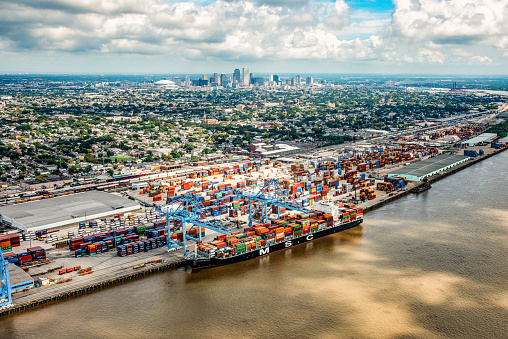 New Orleans, United States - September 28, 2018:  A ship unloading cargo at the Port of New Orleans with the city's skyline in the distance.