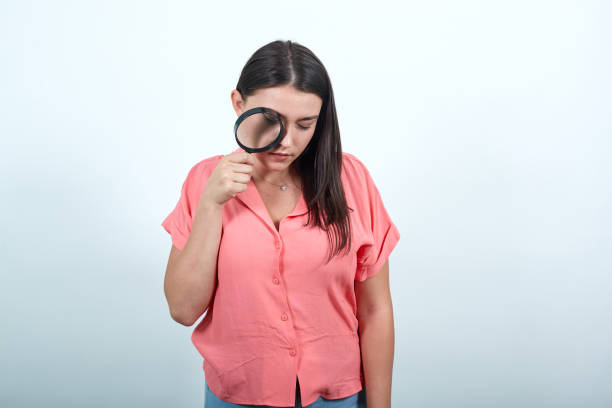 istock Girl with magnifying glass on white background 1195138731
