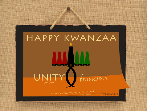 Happy Kwanzaa Day 1 Unity / Umoja Kinara candle calendar blackboard sign hanging on canvas wall