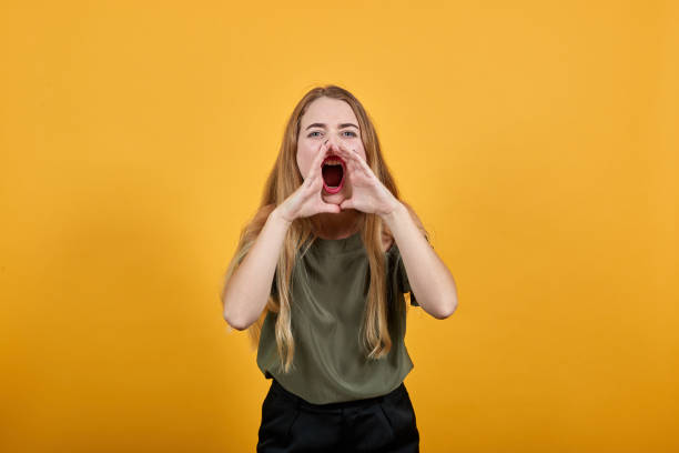 istock Attractive young caucasian woman shouting and announcing something 1195140847