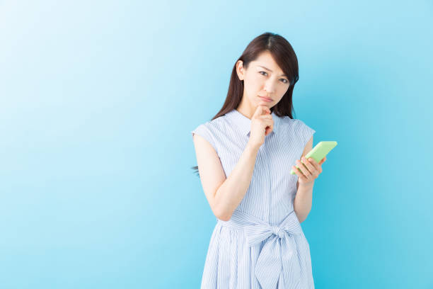istock asian woman to see a smart phone,think, 1195144298