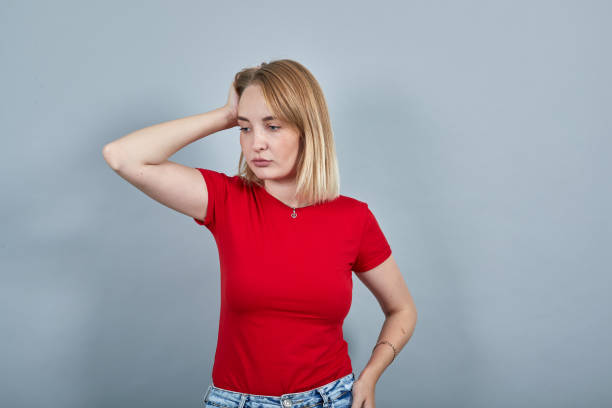 istock Young sad upset perplexed disturb blonde woman posing isolated on grey 1195152125
