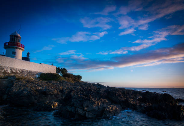istock Lighthouse on the Rocky Shores 1195152778