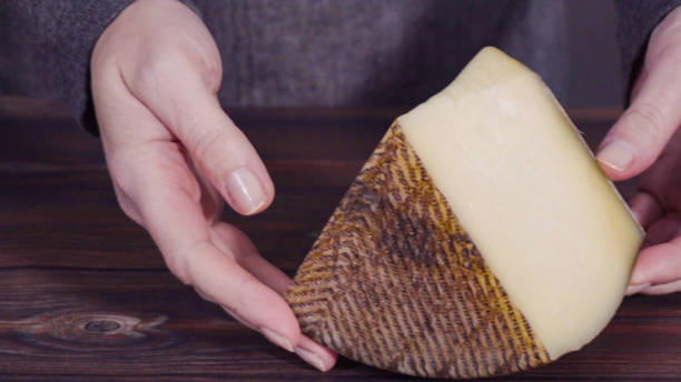 istock Large wedge of Manchego cheese on a rustic wood background. 1195155427