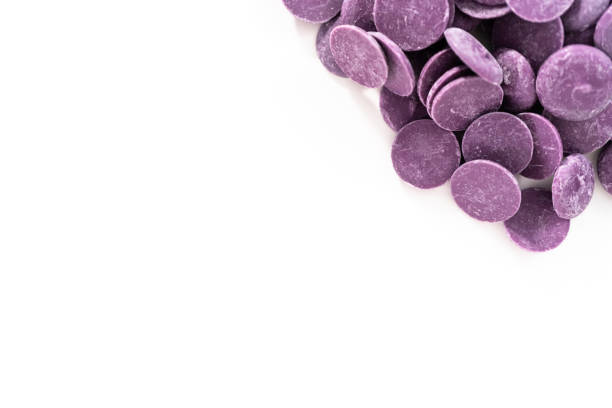 istock Purple round chocolate chips for melting chocolate shapes 1195158236
