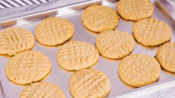 istock Freshly baked peanut butter cookies on baking sheet. 1195158292