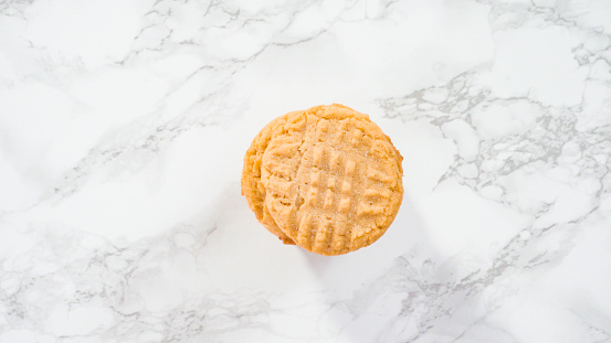 Flat lay. Step by step. Freshly baked peanut butter cookies on marble surface.