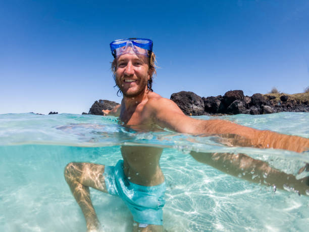 istock Underwater shot of man taking selfie, snorkelling 1195167119