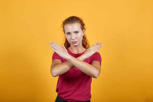 istock Pretty young lady in red shirt doing NO, stop gesture, looking sad 1195167872
