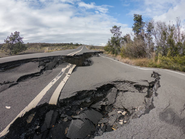 istock Cracked road from volcano activity in Volcano national park, Hawaii 1195168005