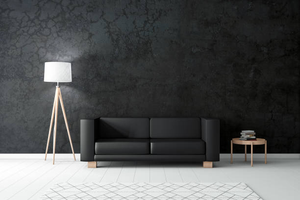 istock Black leather sofa near black concrete wall with modern lamp 1195168849