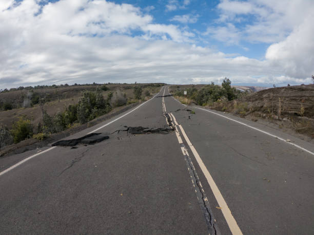 istock Cracked road from volcano activity in Volcano national park, Hawaii 1195168863