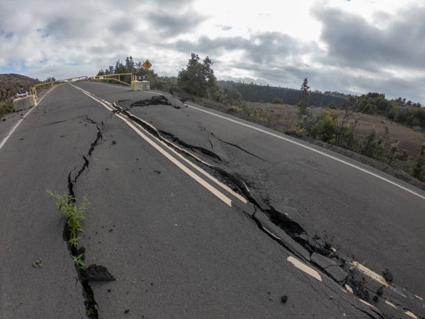 istock Cracked road from volcano activity in Volcano national park, Hawaii 1195170645