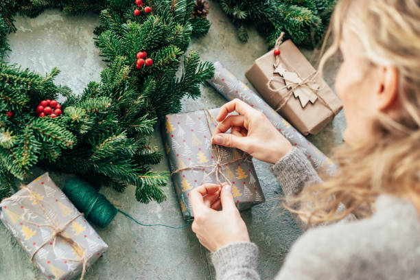 istock woman packs a gift 1195172334