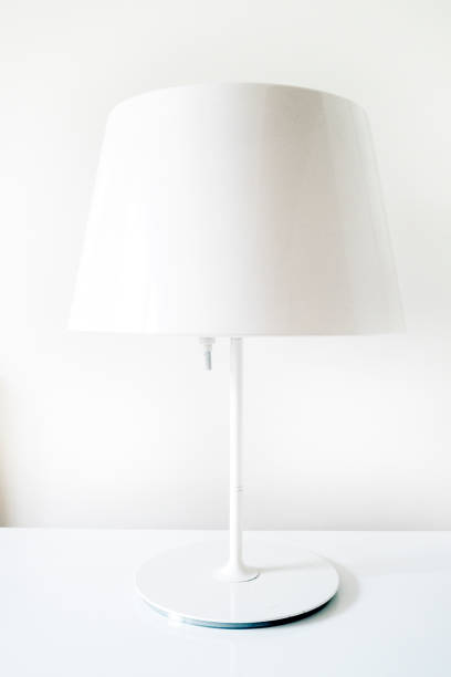 istock Stylish table lamp in white room 1195172370