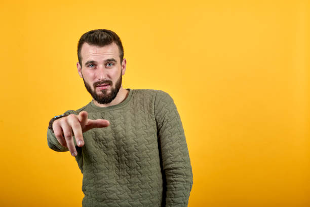 istock Handsome caucasian man pointing finger at camera, looking pretty 1195175685