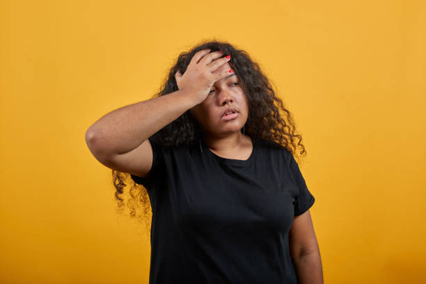 istock Sick woman with overweight keeping hand on forehead, having headache 1195175869