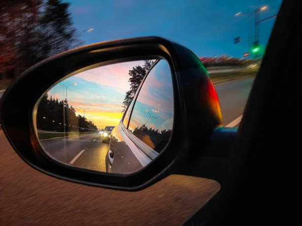 istock Sunset in side mirror of the car 1195181607