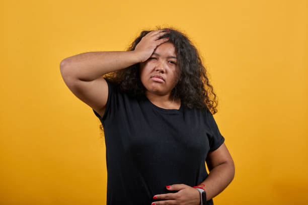 istock Sick young lady keeping hand on head, headache, holding hand on stomach 1195181879