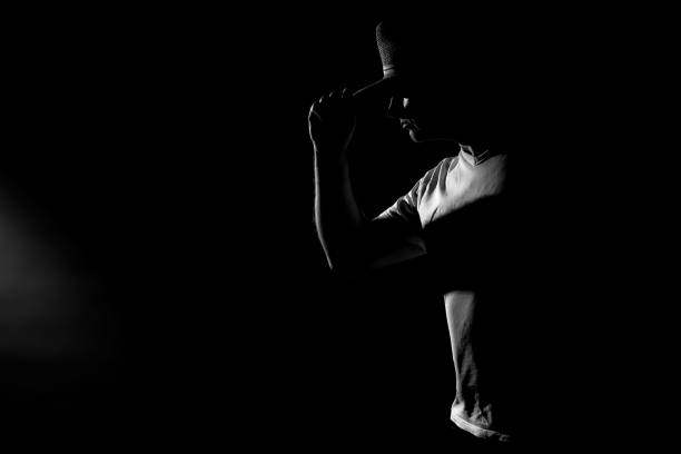 istock Man with hat - hard light outline on black background 1195183616