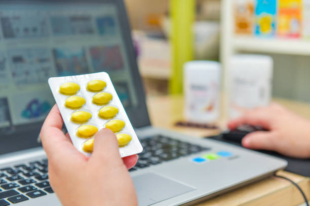 istock Pharmacist using the computer laptop in chemist shop or pharmacy drug store. 1195186852
