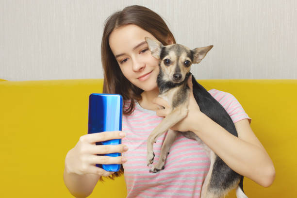 istock Girl makes selfie with a dog 1195187733