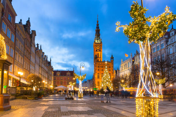 Long Lane in Gdansk with beautiful christmas tree at dusk Long Lane and town hall in Gdansk with beautiful Christmas tree at dusk, Poland gdansk stock pictures, royalty-free photos & images