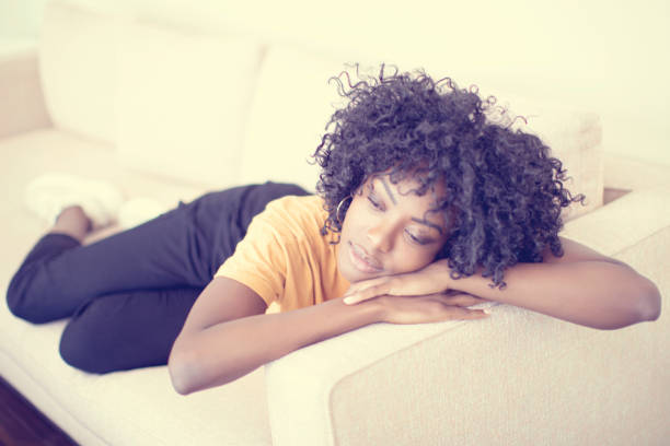 istock Young woman resting on the sofa 1195191033