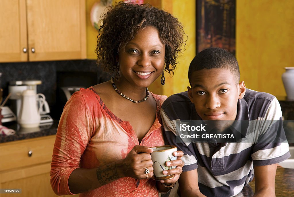 African-American family members in kitchen  Teenager Stock Photo