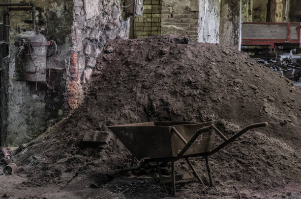 istock wheelbarrow and sand in a foundry 1195191987