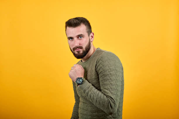 istock Young handsome caucasian man looking at camera, keeping fist up 1195192049
