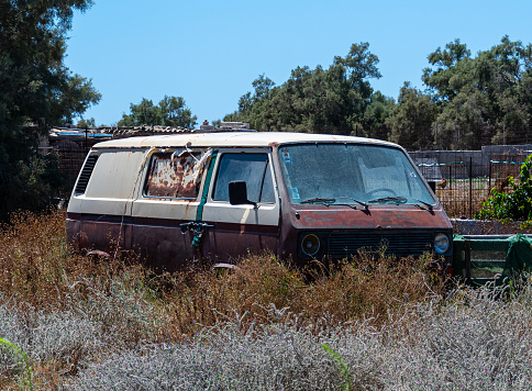 Vilchada, Greece - July 18 2019:   A rusted and long abandonded VW camper van at the sid eof the Vilchada Perissa road