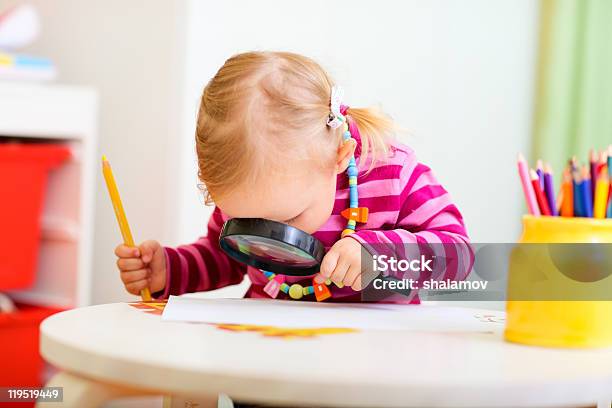 Toddler Girl Looking Through Magnifier Stock Photo - Download Image Now - Magnifying Glass, Girls, Child