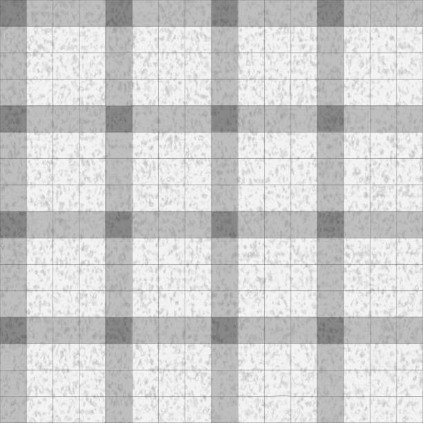 The wall is lined with square gray tiles with a pepper pattern in the form of a large square grid