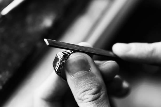 Jeweler At Work In Jewelry Hardworking Goldsmith Working On An Unfinished Gold Ring With His Hands And Tools jewelry craftsperson craft jeweller stock pictures, royalty-free photos & images