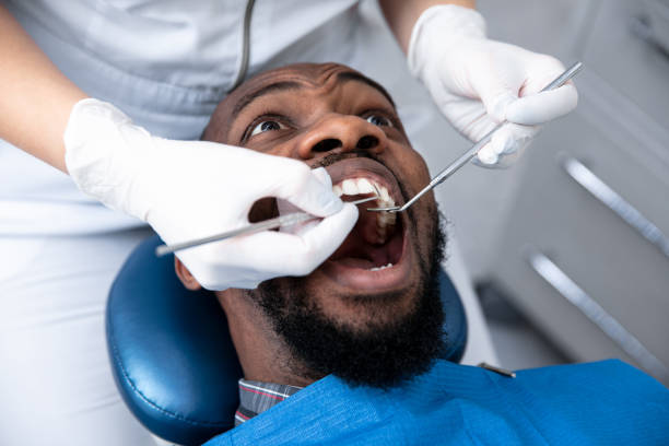 istock Young african-american man visiting dentist's office 1195201932