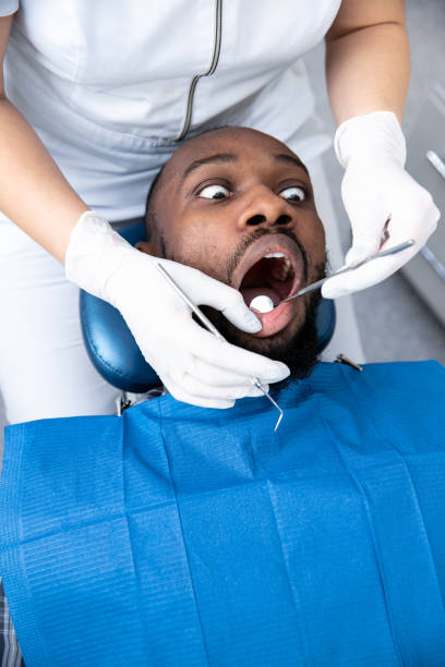 istock Young african-american man visiting dentist's office 1195201937