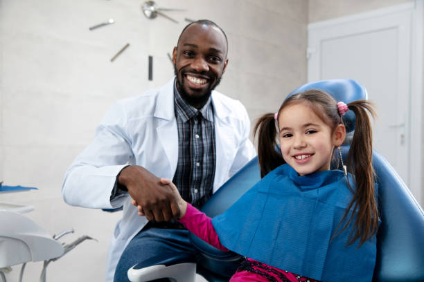 istock Young caucasian girl visiting dentist's office, smiling 1195201962