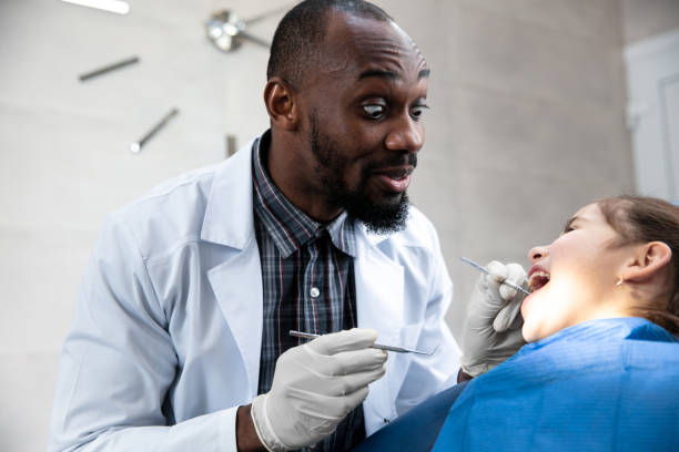 istock Young caucasian girl visiting dentist's office 1195201964