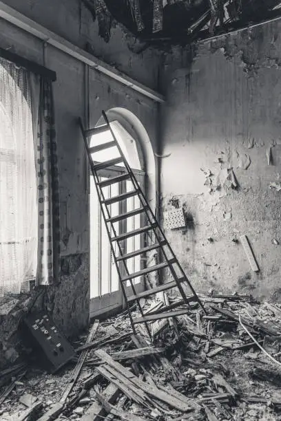 old dirty lost place with a ladder at the door
