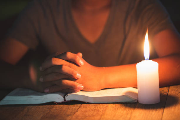 istock Religious Christian boy praying over Bible indoors 1195205169