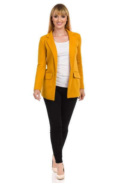 istock Young Woman In Yellow Unbuttoned Jacket Is Walking Towards Camera. Front View. 1195205185